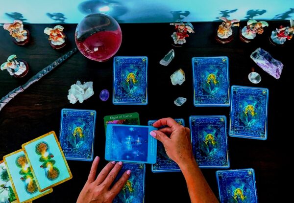 A person performing a tarot card reading Tarot/Oracle/Angel Card Reading